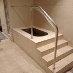 Custom-bent 40 mm polished 316 stainless-steel pool handrail installed at Virgin Active
