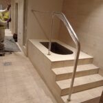 Custom-bent 40 mm polished 316 stainless-steel pool handrail installed at Virgin Active
